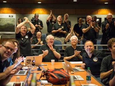 Members of the New Horizons science team react to seeing the spacecraft's last and sharpest image of Pluto before closest approach later in the day, Tuesday, July 14, 2015 at the Johns Hopkins University Applied Physics Laboratory (APL) in Laurel, Maryland. Photo Credit: (NASA/Bill Ingalls)